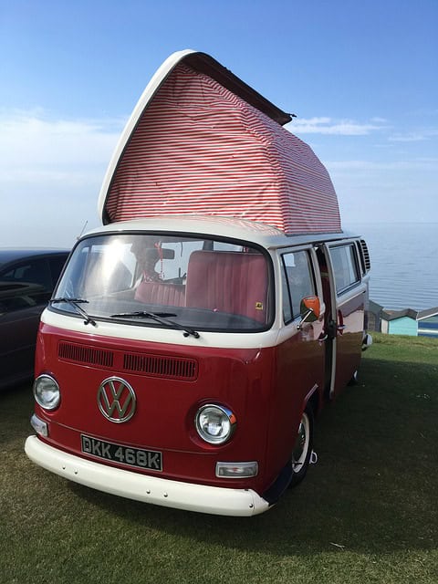 a red and white van with a striped roof