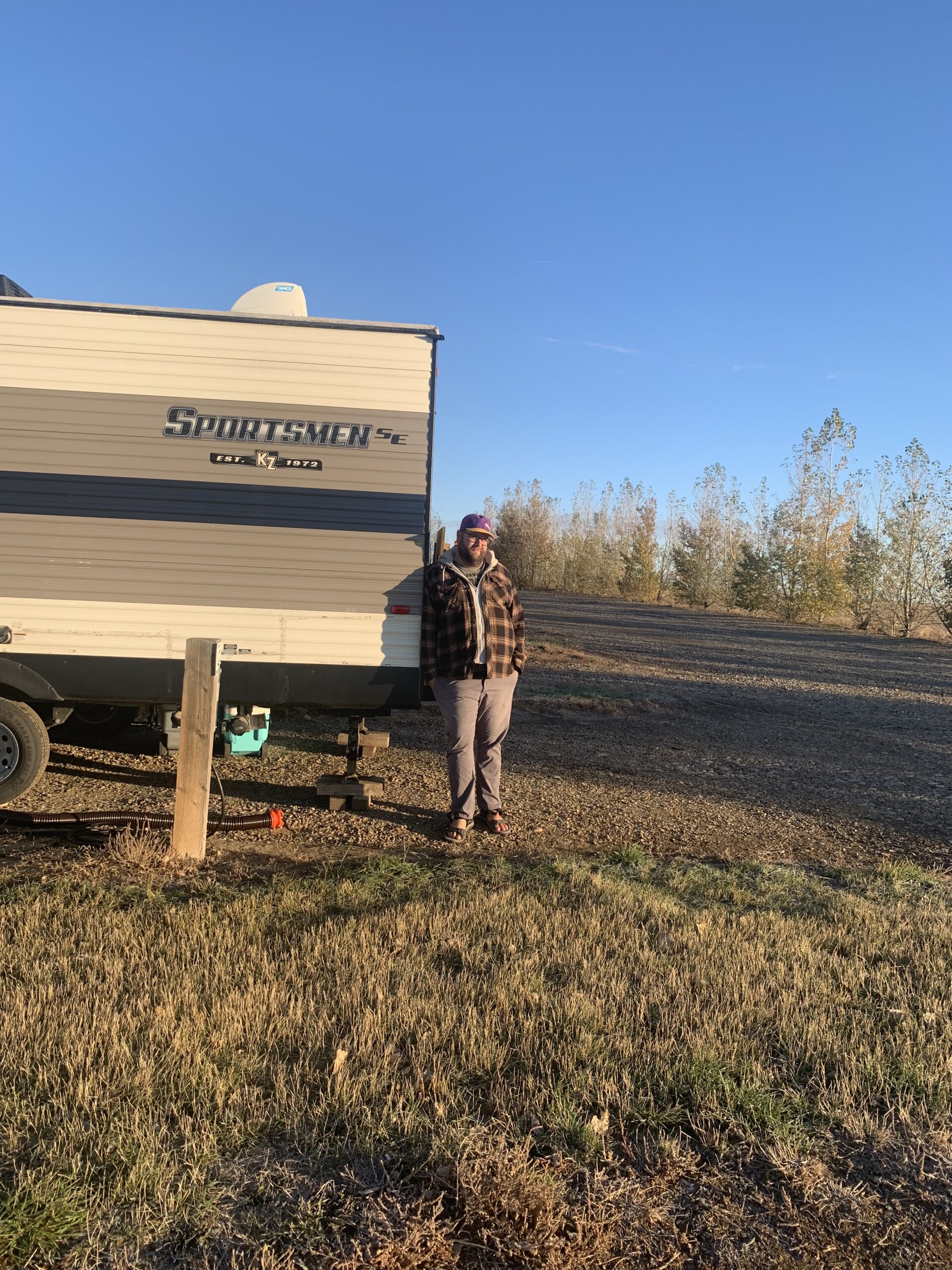 Jeremy beside the family RV at a Saskatchewan campground before travelling toward Costa Rica